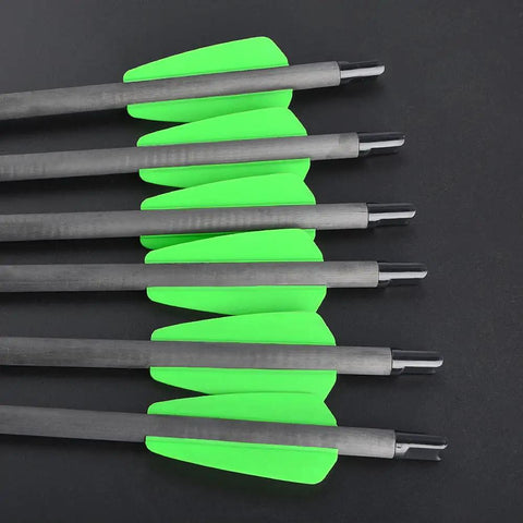 Close-up of 15 Inch Carbon Crossbow Bolts with green fletching, 100 Grain Removable Tips, Moon Nocks, Pro Grade Durable Shafts