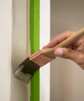 Applying paint next to PaintBlock Multi Surface Painter Tape 2 Inch Wide for Sharp Lines Green 3 Rolls 1.88 in x 60 Yds Medium Adhesion