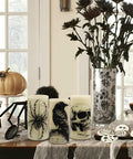 Halloween LED Flameless Candles 3 Pack With 6 Hour Timer Battery Operated 3 Inch Diameter By 6 Inch Height Spooky Decals Featuring Crow Raven Spider On Web And Skull Indoor Halloween Decor For A Chill Haunted Vibe on table setting