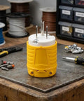 Heavy Duty NEMA 5-15P To Dual Receptacle Adapter 15 Amp 125 Volt rugged yellow ABS design on a workbench.