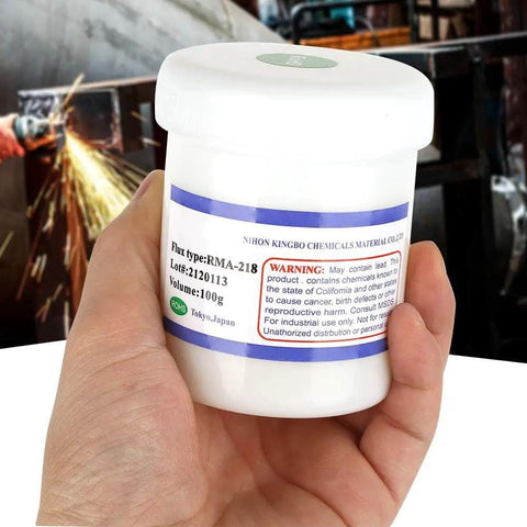 Person holding a 100g container of RMA 218 Flux Paste For BGA Reballing And Soldering, Pro Grade High Performance Solder Paste
