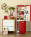 Red fridge open with groceries next to a cabinet, related to Refrigerator Compressor Relay And Overload Kit 5 Pack.