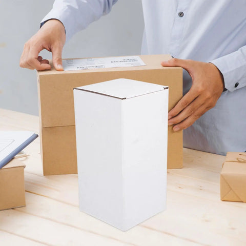 Person handling a shipping box with 10 Pack White Corrugated Cardboard Shipping Boxes With High Durability And Stable Weight Support nearby