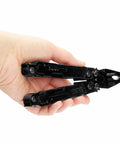 Hand holding PowerAccess Deluxe All Purpose Heavy Duty Stainless Steel Multi Tool With Nylon Sheath Twenty One Tools Two Knife Blades