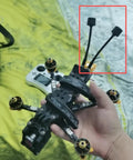Hand holding RC drone with High Gain FivePointEightGHz FPV Antenna for RC Drones LHCP with SMA Male TwoPointFive dB Signal Boost