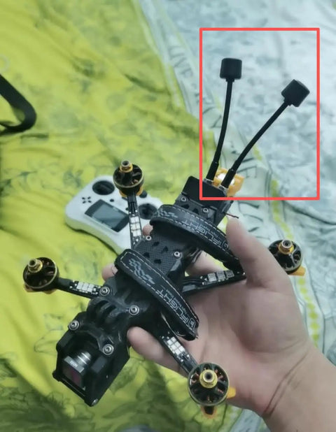 Hand holding RC drone with High Gain FivePointEightGHz FPV Antenna for RC Drones LHCP with SMA Male TwoPointFive dB Signal Boost