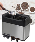 Automatic Espresso Knock Box Cleaner Game Changer Electric Portafilter Grounds Remover with brush and portafilter attached.