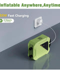 Electric Paddle Board Pump 20 PSI High-Pressure Rechargeable SUP Air Pump charging via wall socket on gray surface.