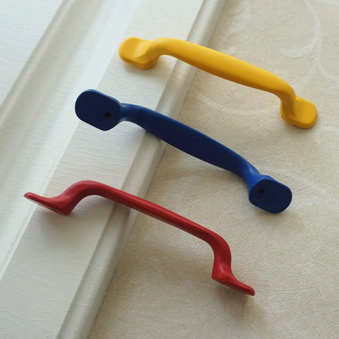 Hella Durable Zinc Alloy Drawer Knobs And Kitchen Cabinet Handles Built Tough For Daily Use Featuring Easy Grip Pulls For Dressers And Kids Furniture Hardware In Totally Dope Colors, featuring red, blue, and yellow knobs.