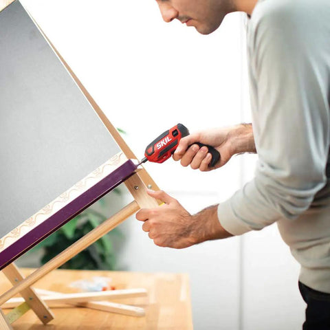 Person using Rechargeable 4V Cordless Screwdriver Kit with 9 Bits on wooden board, ideal for tight spaces and DIY projects