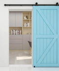 Interior view of a blue barn wood door mounted using a Five And Half Foot Sliding Barn Door Hardware Kit With Adjustable Floor Guide And Top Mount Track For Barn Wood Doors Durable Steel Construction With Nylon Wheel Hangers For Smooth Quiet Operation Frosted Black Finish Fits One And Three Eighths Inch Doors in home study.