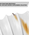 Close-up of puncture-resistant Beefy Heavy Duty Two And A Half Inch Clear PVC Dust Collection Hose with visible wood chip.