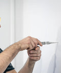 Person using Spring Loaded Center Punch Marker For Wood Metal Plastic With Palm Cushion Cap 5 Inch Automatic Scriber Tool on wall