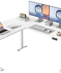 Spacious YIHAYO L Shaped Standing Desk Adjustable Height Electric Corner Computer Desk With Splice Board For Home Office showcasing dual monitors, laptop, and accessories.