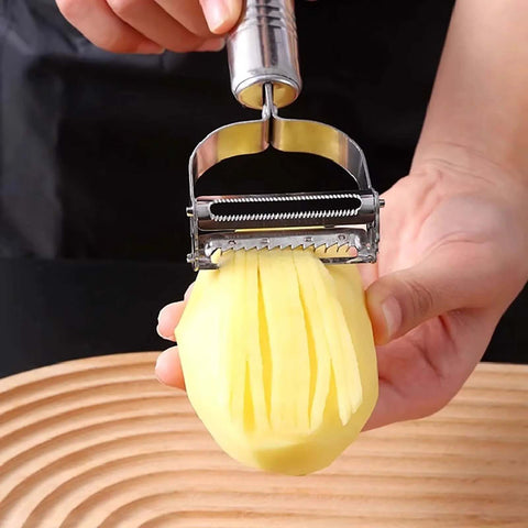 Front view of stainless steel 2-in-1 vegetable peeler and crinkle cutter slicing a peeled potato into fries
