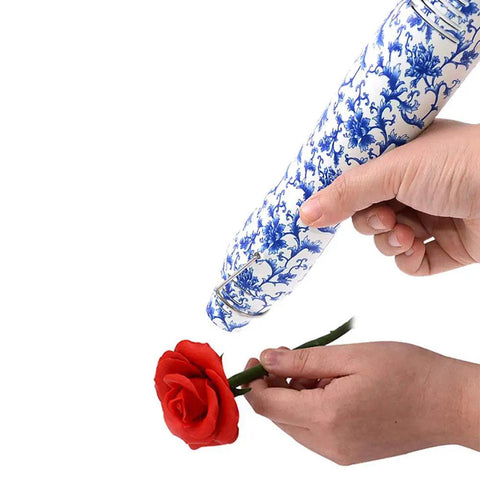 Person using Dope Resin Heat Gun 300W With 6.6Ft Cable For Crafts And DIY Projects on a red rose, featuring floral patterned handle