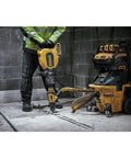 High Power 60V Brushless Cordless Chipping Hammer With SDS Max Chuck and Rear Handle Setup in action on concrete floor.