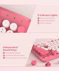 Close-up of hot pink typewriter style wireless keyboard with round keycaps and indicator lights for Mac Windows PC laptop