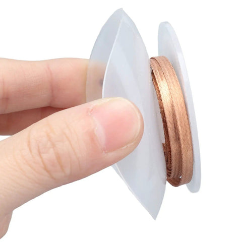 Hand holding Pro-Grade Desoldering Wick Copper Solder Braid for Electronics Repair, 1.5 Meter, 3.5mm Width