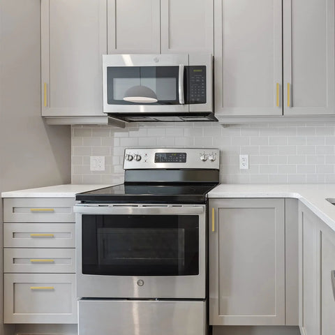 Modern kitchen with 30 Pack 5 Inch Square Cabinet Handles In Brushed Brass Finish Stainless Steel Kitchen Hardware Pulls With 128mm Hole Center Designed For Cabinets Wardrobes Chests And Cupboards Gold, installed on grey cabinets.