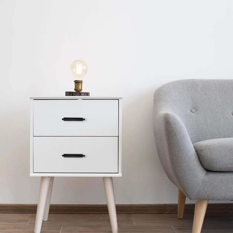 4 Pack Self Adhesive Cabinet Handles No Drill Drawer Pulls 5.27 Inch on a white drawer unit next to a gray chair