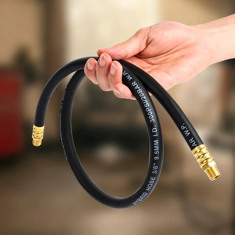 Tough As Nails Air Compressor Whip Hose 3/8 Inch By 3 Feet held in hand, showcasing flexible black hybrid rubber PVC design with brass fittings.