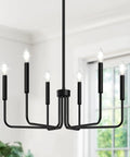 Six Light Farmhouse Industrial Chandelier With Matte Black Finish installed in bright room