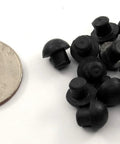 Small Rubber Push In Mushroom Bumpers Set Of Eight For Three Sixteenth Inch Openings With Eleven Thirty Seconds Of An Inch Diameter Durable Bumpers next to a coin for scale.