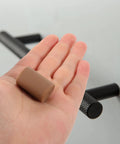 Brown Silicone Corner Guards For Furniture And Drawer Handles Soft Round Edge Protectors in a person's hand.