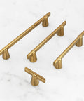 Gold Cabinet Handles 3 Inch 76mm Pack Of 3 Minimalist Modern Dresser Pulls with conical bases displayed on marble surface