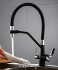 GAZOGJ 3-Way Kitchen Faucet with 360°Rotatable Shower Head, stylish black finish, dual lever tap in use over a sink.
