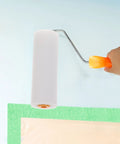 Person using a mini foam paint roller cover on a wall, part of 10 Pack High Density Foam Paint Roller Covers Mini Wall Paint Rollers Quick And Dirty Setup Knockout Coverage For Water Based And Oil Based Paints Gloss Stains Real Smooth Finish Home Workshop Needs.