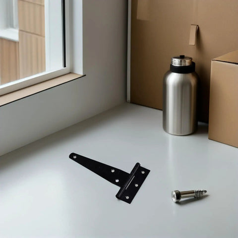 Heavy Duty Galvanized Zinc Alloy T Post Gate Hinges With Screws on a table near a window, showcasing triangular support design.