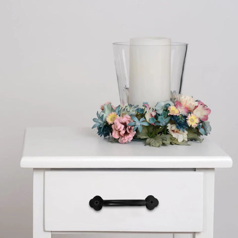 White cabinet with Vintage Metal Drawer Pulls Three Piece Set, Rustic Black Alloy Cabinet Handles, with a floral centerpiece.
