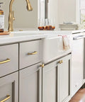 Champagne Bronze Cabinet Knob 1-1/4 Inch Diameter For Cabinets And Drawers, Renown Series in kitchen on gray cabinetry