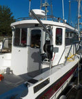 Boat docked with Beefy Heavy Duty Crab Pot Puller With 2.3 HP 90 To 1 Powerdrive Gear System and UHMW Gunnel Mount.