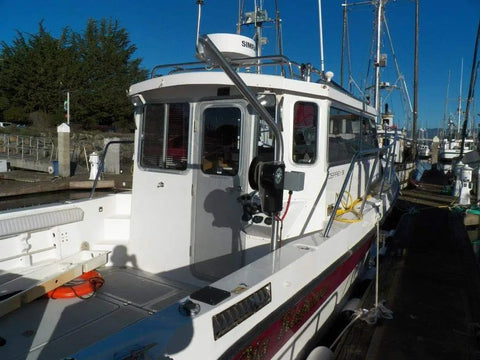 Boat docked with Beefy Heavy Duty Crab Pot Puller With 2.3 HP 90 To 1 Powerdrive Gear System and UHMW Gunnel Mount.