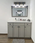 Farmhouse Style 3-Light Mason Jar Wall Sconce With Wood Base And Glass Shades above bathroom vanity with mirror.