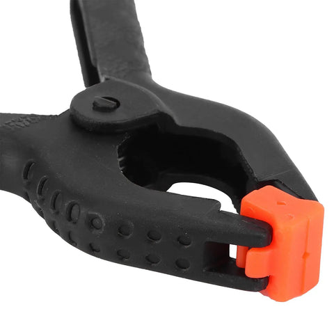 Top Tier 10 Piece Spring Clamps For Woodworking And DIY Projects With Ergonomic Handles That Grip Hard To Hold Boards Securely While You Paint Build Crafts Or Work In Your Studio Without Any Slip Ups On This Ultimate Hand Tool Kit. black plastic spring clamp with orange tip