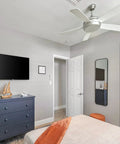 Ceiling fan with sloped ceiling fan adapter for angled ceilings up to 45 degrees, in a bedroom with sand nickel finish.