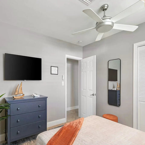 Ceiling fan with sloped ceiling fan adapter for angled ceilings up to 45 degrees, in a bedroom with sand nickel finish.