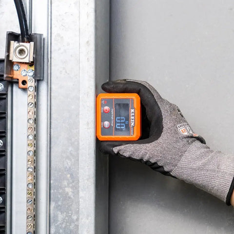 Hand holding an Angle Finder Digital Gauge with Strong Magnetic Base for Quick Conversions between Degrees, Percent Grade.