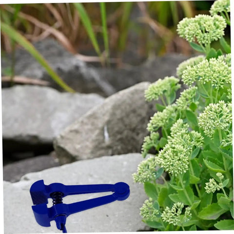 Heavy Duty 4.72 Inch Hand Clamp Vise For Woodworking And Metalworking Portable Steel With Fastening Knob And Slip Resistant Grip For Pro Grade Hold And Ideal For Home Shop Use With Precise Project Finishes. Blue hand clamp vise on rock outdoors