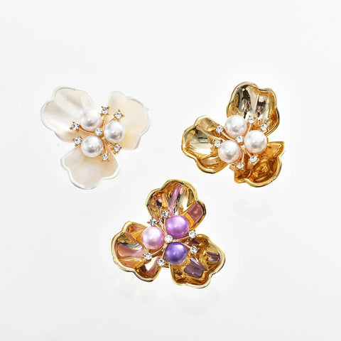 Shell Pearl Flower Cufflinks And Shirt Sleeve Button Covers, Boss Level Shine In Elegant Alloy Electroplated Finish, Gardenia Inspired Purple Pearl Gold Look, Luxury Dress Shirt Jewelry For A Sharp Modern Style. Three cufflinks with pearl-centered flower designs in white, gold, and purple.