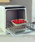 Fully Automatic Portable Countertop Dishwasher Crafted From Premium Stainless Steel Packs LED Control Panel with cherries in basket.
