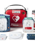 Philips HeartStart Home AED Defibrillator bundle: blue main unit with pads, red carrying case, safety pack.
