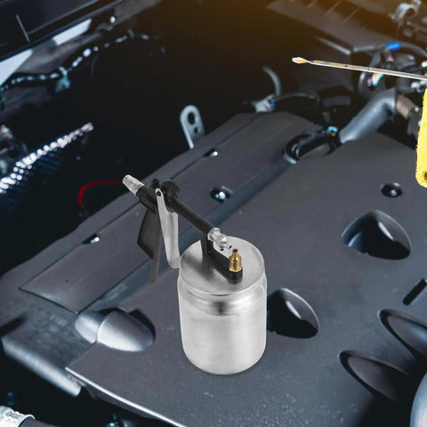 Real Deal Pneumatic Paint Sprayer With Tough Metal Housing for auto work on engine components, showcasing its steel structure.