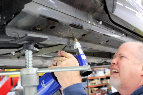 Three Eighths Inch Capacity Pneumatic Rivet Nut Setting Kit With M4 M5 M6 M8 M10 And One Quarter Inch being used on car frame