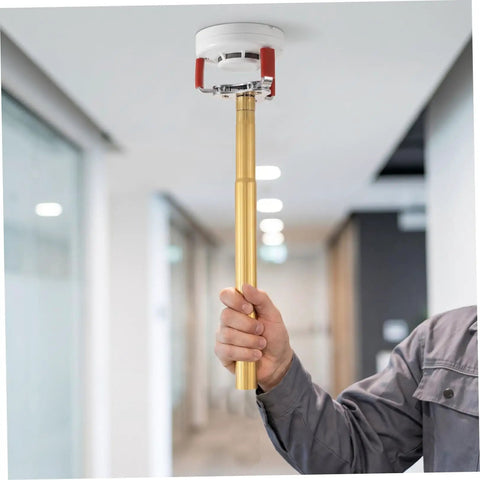 Ladder Free Smoke Sensor Removal Tool With 11 Point Eight Inch Extended Reach Stick being used to remove a high ceiling smoke detector