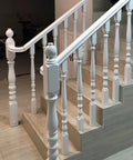 White Wooden Balusters Top Tier Quality with solid poplar material on staircase, showcasing classic design for easy DIY install.